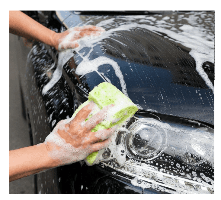 A person washing their car with a sponge